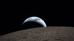 Crescent Earth rising above the cratered lunar surface, photographed by the Artemis 2 crew from deep space,